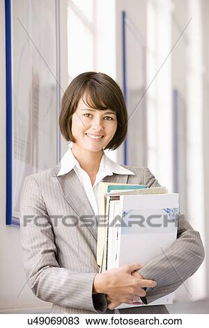 Portrait of businesswoman with files View Large Photo Image Stock Image - Portrait of businesswoman with files. Fotosearch