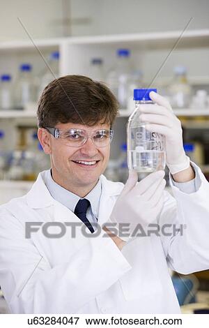 Stock Photo - Portrait of mid adult scientist. Fotosearch