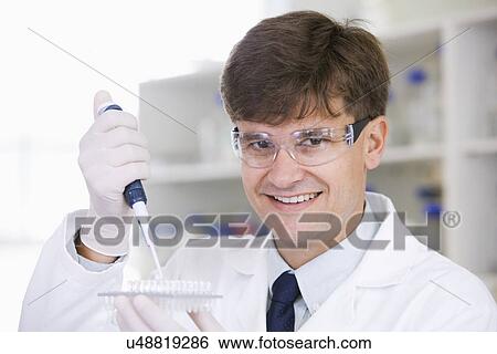 Stock Photograph - Portrait of mid adult scientist. Fotosearch