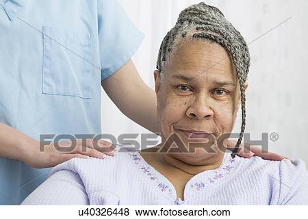 Stock Photo - Portrait of senior patient and nurse in nursing home. Fotosearch