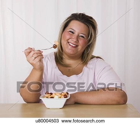 Portrait of smiling young woman eating fruit salad View Large Photo Image Stock Image - Portrait of smiling young woman eating fruit salad. Fotosearch