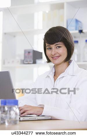 Stock Photo - Portrait of young female scientist. Fotosearch