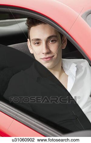 Portrait of young man in car View Large Photo Image Stock Image - Portrait of young man in car. Fotosearch