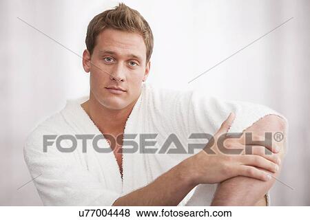 Portrait of young man wearing bathro in spa View Large Photo Image Stock Photo - Portrait of young man wearing bathro in spa. Fotosearch