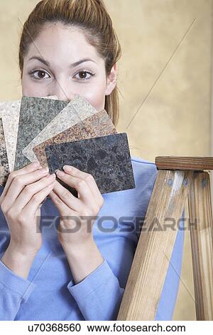 Portrait of young woman holding countertop samples View Large Photo Image Stock Image - Portrait of young woman holding countertop samples. Fotosearch