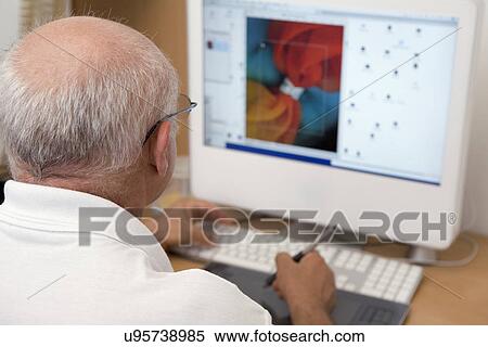 Rear view of graphic designer working on computer View Large Photo Image Stock Photography - Rear view of graphic designer working on computer. Fotosearch