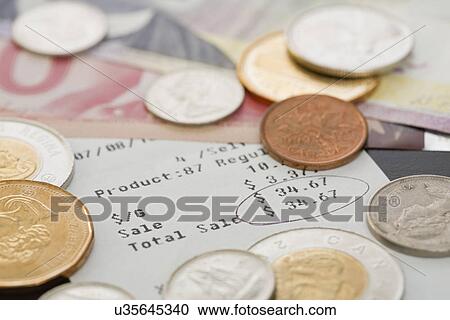 Stock Image - Restaurant receipt and money. Fotosearch