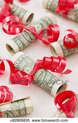 Stock Photography - Rolled up dollar bills. Fotosearch