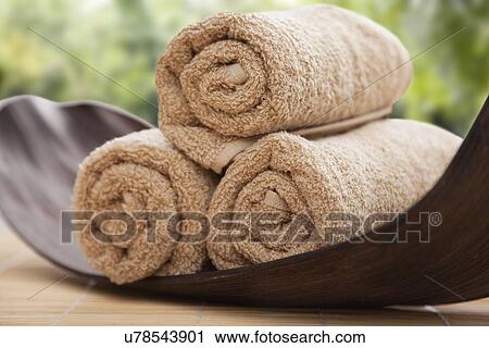 Stock Image - Rolled up towels in spa, Studio shot. Fotosearch