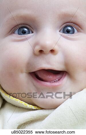 Stock Photography - Russia, Voronezh, Baby (0-1month) lying in bed, looking at hanging toys. Fotosearch