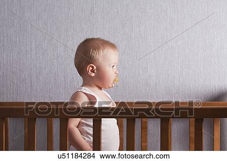 Picture - Russia, Voronezh, baby boy (12-17 months) in crib. Fotosearch