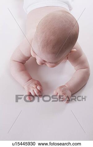 Stock Image - Russia, Voronezh, baby boy (2-5 months) crawling. Fotosearch