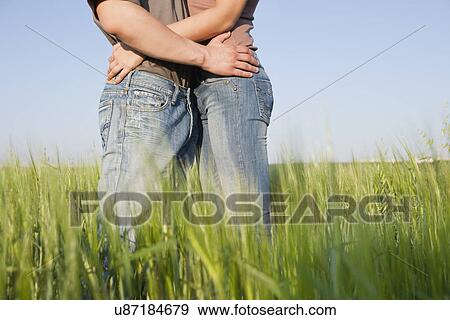 Russia, Voronezh, couple embracing in field View Large Photo Image Stock Photo - Russia, Voronezh, couple embracing in field. Fotosearch