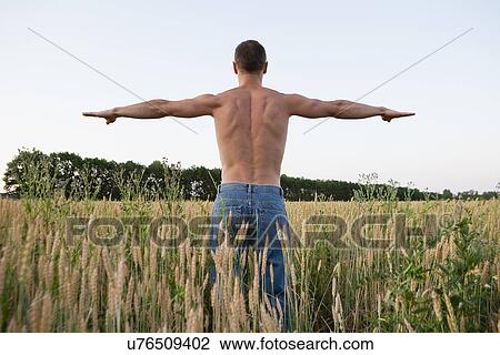 Stock Image - Russia, Voronezh, man exercising in field. Fotosearch