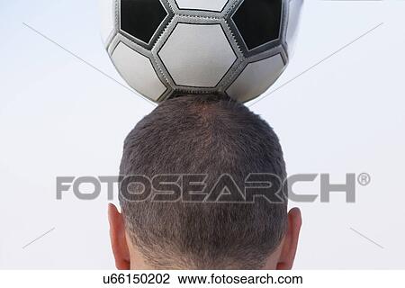 Russia, Voronezh, man holding soccer ball on head View Large Photo Image Stock Image - Russia, Voronezh, man holding soccer ball on head. Fotosearch