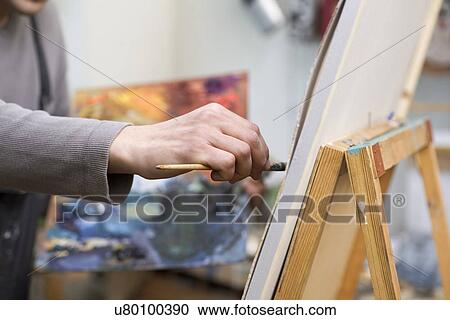 Stock Image - Russia, Voronezh, man painting on canvas. Fotosearch