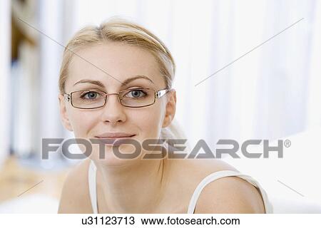 Stock Image - Russia, Voronezh, Portrait of smiling young woman. Fotosearch