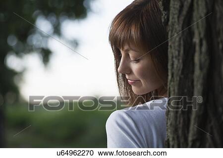 Russia, Voronezh, woman behind tree View Large Photo Image Stock Image - Russia, Voronezh, woman behind tree. Fotosearch