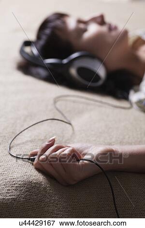 Russia, Voronezh, woman listening to music on headphones View Large Photo Image Stock Photo - Russia, Voronezh, woman listening to music on headphones. Fotosearch
