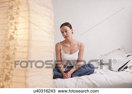 Russia, Voronezh, woman sitting on bed View Large Photo Image Stock Image - Russia, Voronezh, woman sitting on bed. Fotosearch
