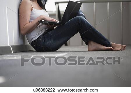 Russia, Voronezh, woman sitting on floor with laptop View Large Photo Image Stock Image - Russia, Voronezh, woman sitting on floor with laptop. Fotosearch