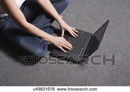Russia, Voronezh, woman sitting on floor with laptop View Large Photo Image Stock Photo - Russia, Voronezh, woman sitting on floor with laptop. Fotosearch