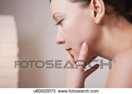 Stock Image - Russia, Voronezh, woman with hand on chin. Fotosearch