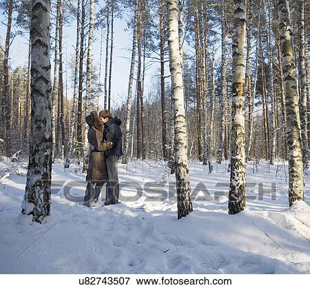 Stock Photo - Russia, Voronezh, Young couple kissing in snowy park. Fotosearch