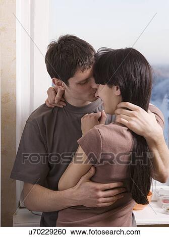 Russia, Voronezh, Young couple embracing in kitchen View Large Photo Image Stock Image - Russia, Voronezh, Young couple embracing in kitchen. Fotosearch