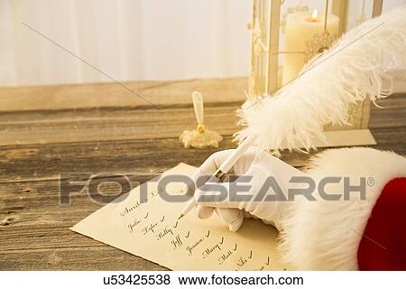 Stock Photo - Santa Claus checking to do list. Fotosearch
