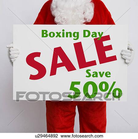 Santa Claus holding Boxing Day sale sign View Large Photo Image Stock Image - Santa Claus holding Boxing Day sale sign. Fotosearch