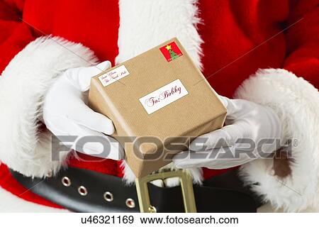 Stock Photo - Santa Claus holding gift. Fotosearch