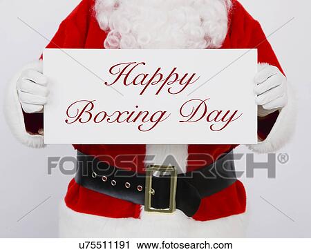Stock Image - Santa Claus holding Happy Boxing Day sign. Fotosearch