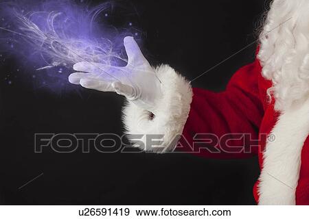 Stock Photo - Santa claus with hologram. Fotosearch