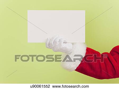 Stock Image - Santa clause holding blank card. Fotosearch