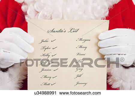 Stock Image - Santa clause holding Christmas list. Fotosearch