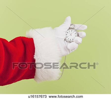 Stock Image - Santa clause holding pocket watch. Fotosearch