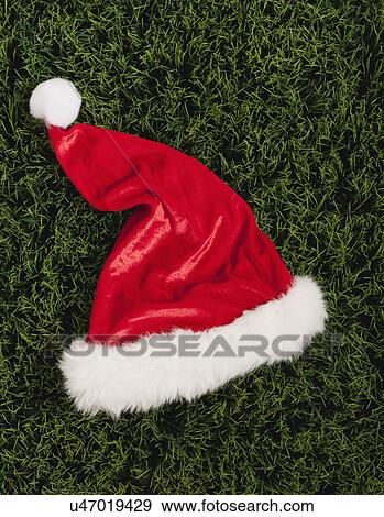 Stock Photo - Santa hat on grass, directly above. Fotosearch