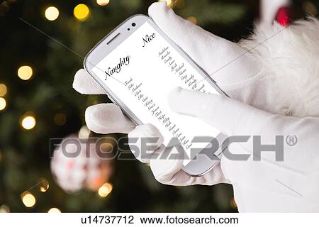 Stock Image - Santa holding cell phone. Fotosearch