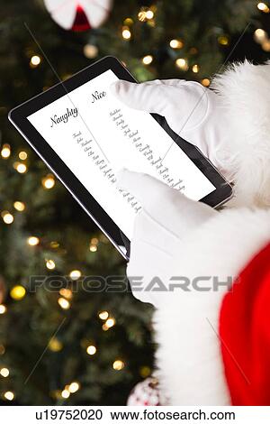 Stock Image - Santa holding digital tablet. Fotosearch