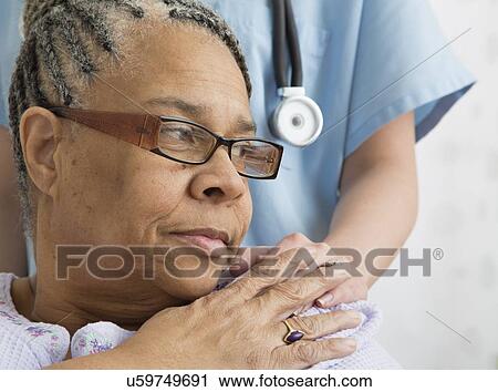 Stock Image - Senior patient and nurse in nursing home. Fotosearch