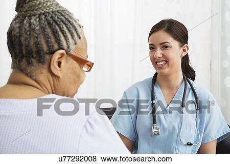 Stock Photo - Senior woman and nurse during check-up. Fotosearch