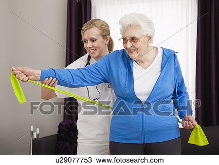 Senior woman exercising with nurse View Large Photo Image Stock Image - Senior woman exercising with nurse. Fotosearch
