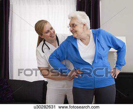Senior woman exercising with nurse View Large Photo Image Stock Image - Senior woman exercising with nurse. Fotosearch