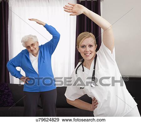 Senior woman exercising with nurse View Large Photo Image Stock Photo - Senior woman exercising with nurse. Fotosearch