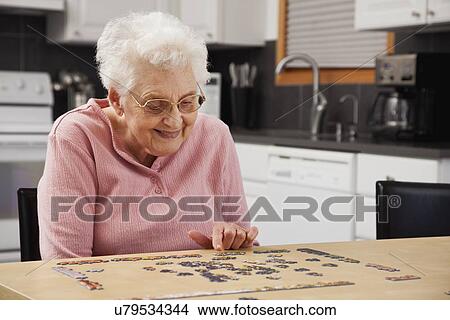 Senior woman playing puzzle View Large Photo Image Picture - Senior woman playing puzzle. Fotosearch