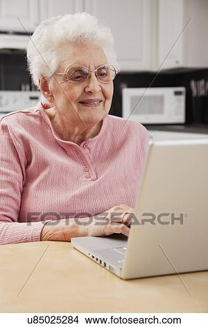 Senior woman using laptop View Large Photo Image Picture - Senior woman using laptop. Fotosearch