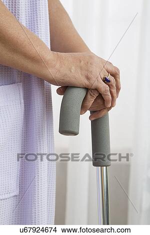 Senior woman with cane, close-up View Large Photo Image Picture - Senior woman with cane, close-up. Fotosearch
