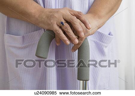 Stock Photography - Senior woman with cane, close-up. Fotosearch