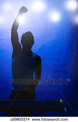 Picture - Silhouette of male musician on stage. Fotosearch